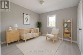 Markham (Royal Orchard) townhouse for rent - A baby room with a crib, a chair, a dresser and a shelf.
