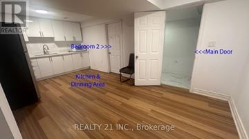 Ajax (Northeast Ajax) apartment for rent - A room with a kitchen and dining area with a black fridge and a white door.
