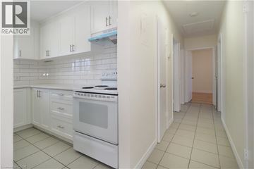 Waterloo apartment for rent - A white kitchen with a white oven and white cabinets.