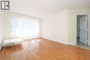 Waterloo apartment for rent - A bedroom with a bed and a wooden floor.