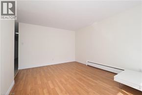 Waterloo apartment for rent - A room with wooden floors and white walls.
