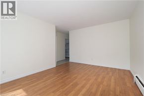Waterloo apartment for rent - A room with wooden flooring and white walls.
