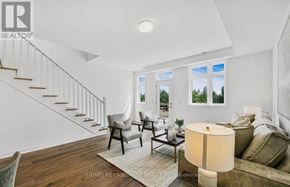 Oakville (Go Glenorchy) townhouse for rent - A well-lit living room with a staircase and a couch.