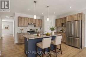 Russell apartment for rent - A modern kitchen with wooden cabinets and a blue island.