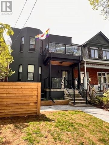 Toronto (South Parkdale) apartment for rent - A modern house with a balcony and a flag.