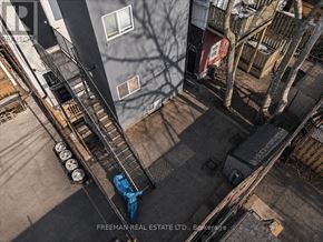 Toronto (South Parkdale) apartment for rent - A person is standing on a fire escape with a blue tarp on it.