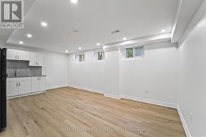 Mississauga (Clarkson) apartment for rent - A spacious room with wooden flooring and white walls.