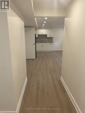 Mississauga (Clarkson) apartment for rent - A hallway with wood flooring and white walls.