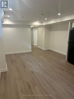 Mississauga (Clarkson) apartment for rent - A room with wood flooring and white walls, with a door on the right.