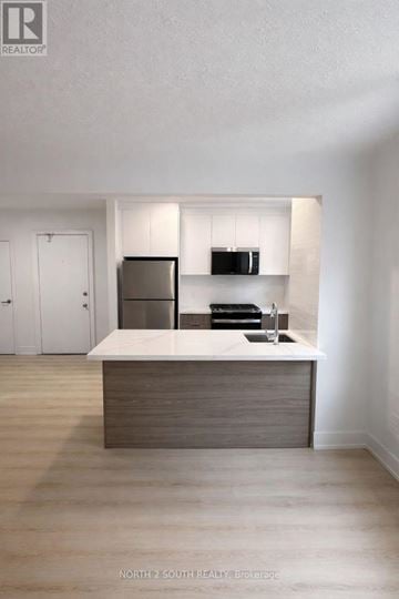 Hamilton (Stipley) multi-family for rent - A modern kitchen with a wooden island and stainless steel appliances.
