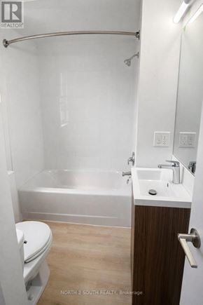 Hamilton (Stipley) multi-family for rent - A white bathroom with a toilet, sink and bathtub.