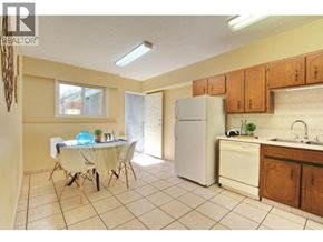 Burnaby apartment for rent - A kitchen with a table and chairs in the middle of the room.