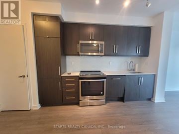 Toronto (Willowdale West) condo for rent - A kitchen with dark wood cabinets and stainless steel appliances.