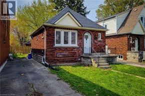 Hamilton apartment for rent - A small red brick house with a white door and windows.