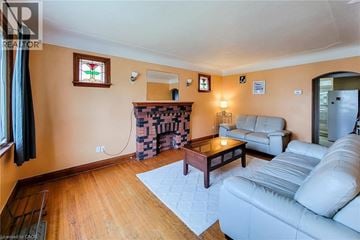 Hamilton apartment for rent - A living room with a white couch and a fireplace.
