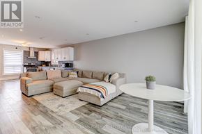 Oshawa (Donevan) apartment for rent - A living room with a white couch and a small table.