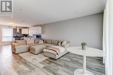 Oshawa (Donevan) apartment for rent - A living room with a white couch and a small table.
