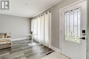 Oshawa (Donevan) apartment for rent - A white door with a glass window and a metal frame is on the right side of the image.