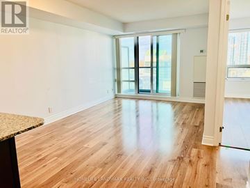 Markham (Unionville) condo for rent - A room with wooden flooring and a sliding glass door.