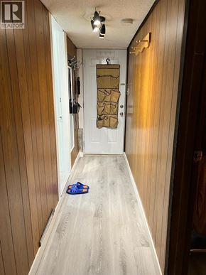 Vancouver apartment for rent - A hallway with a door and a pair of shoes on the floor.