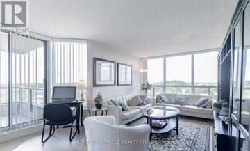 Brampton (Queen Street Corridor) condo for rent - A living room with a black chair and a white couch.