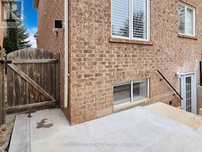 Oakville (Wm Westmount) apartment for rent - A brick house with a wooden gate and a window.