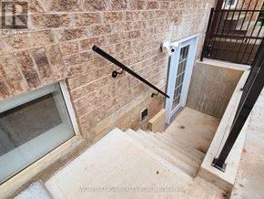 Oakville (Wm Westmount) apartment for rent - A staircase with a metal railing and a glass door at the top.
