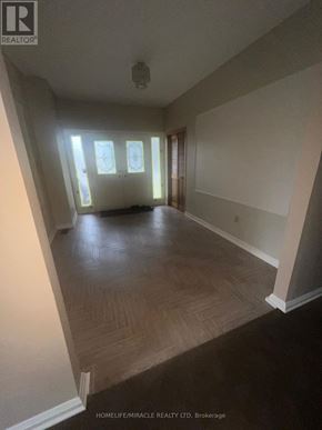 Caledon (Palgrave) apartment for rent - A spacious room with wooden flooring and a large window.