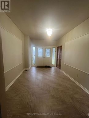 Caledon (Palgrave) apartment for rent - A long hallway with wood flooring and white walls.