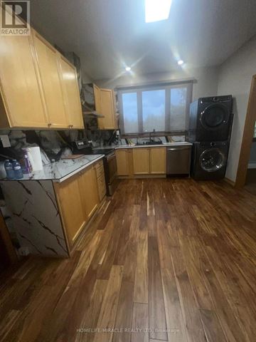 Caledon (Palgrave) apartment for rent - A kitchen with wooden floors and cabinets.