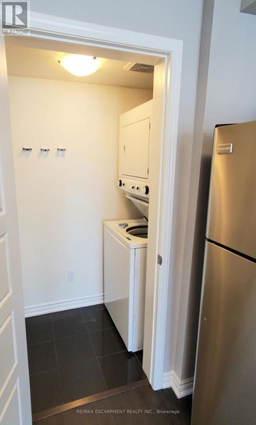 Kitchener townhouse for rent - A small kitchen with a refrigerator and a cabinet.