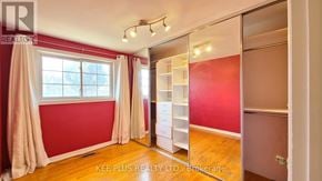 Toronto (Morningside) apartment for rent - A room with red walls and a large window with curtains.