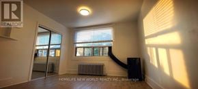Toronto (Corso Italia-Davenport) apartment for rent - A room with a slanted ceiling and a window with blinds.