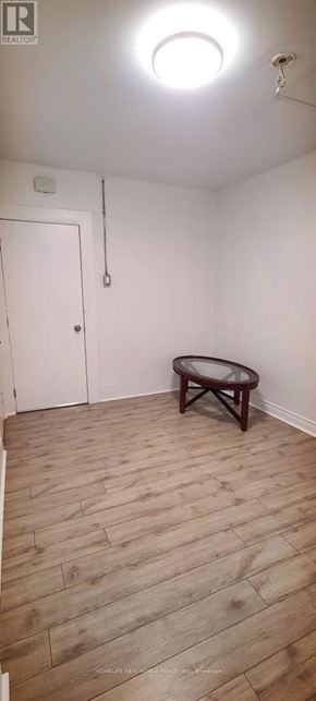 Toronto (Corso Italia-Davenport) apartment for rent - A room with a white door and a wooden floor.