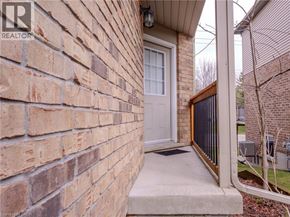 Waterloo townhouse for rent - A brick wall with a white door and a black gate.