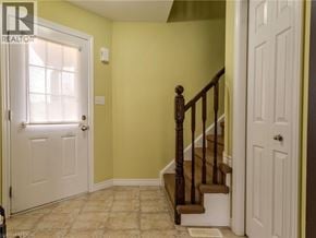 Waterloo townhouse for rent - A hallway with a staircase leading to the second floor.