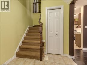 Waterloo townhouse for rent - A brown carpeted staircase leads to a white door.