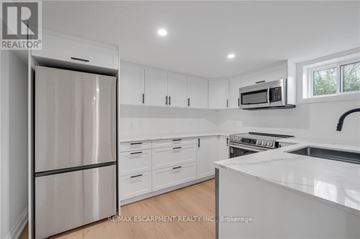 Burlington (Mountainside) apartment for rent - A modern kitchen with white cabinets and stainless steel appliances.