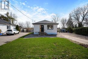 Burlington (Mountainside) apartment for rent - A small white house with a black roof and a car parked in front.