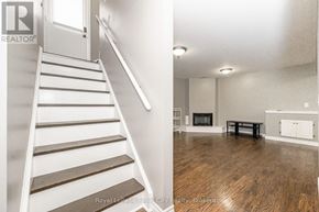 Guelph (Grange Road) apartment for rent - A white staircase with wooden steps leads to a living room with a black coffee table.