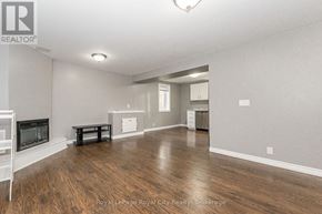 Guelph (Grange Road) apartment for rent - A spacious living room with wood flooring and a television.