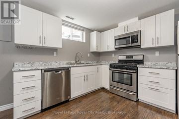 Guelph (Grange Road) apartment for rent - A kitchen with white cabinets and a granite countertop.