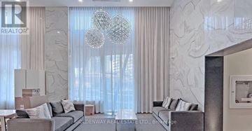 Toronto (Willowdale West) condo for rent - A living room with a grey sofa and a large window with curtains.