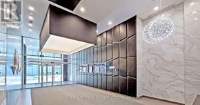 Toronto (Willowdale West) condo for rent - A modern office lobby with a glass wall and a chandelier.