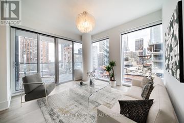 Toronto (Church-Yonge Corridor) condo for rent - A living room with a couch, chair, and a table with a plant on it.