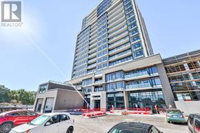 Milton (Co Coates) condo for rent - A modern building with a parking lot in front of it.
