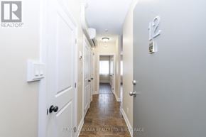 Fort Erie (Central) multi-family for rent - A hallway with white doors and a wooden floor.