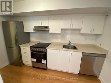 Toronto (Bendale) apartment for rent - A kitchen with white cabinets and a stainless steel dishwasher.