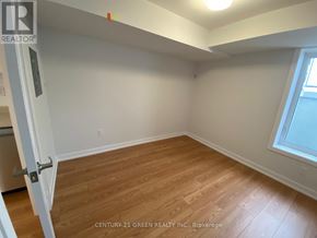 Toronto (Bendale) apartment for rent - A room with wooden flooring and white walls, with a door on the left and a window on the right.