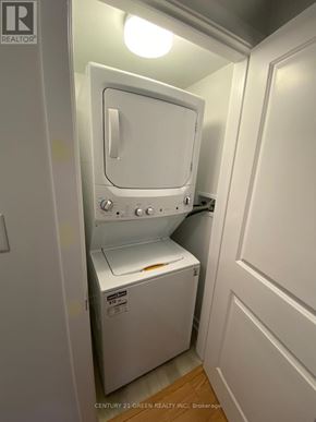 Toronto (Bendale) apartment for rent - A white washer and dryer in a small laundry room.